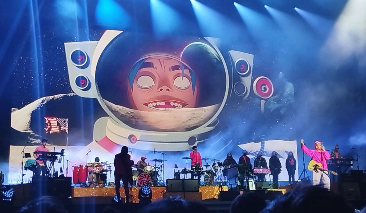 Gorillaz concert-goers witness a vibrant display of animation and live music on stage.