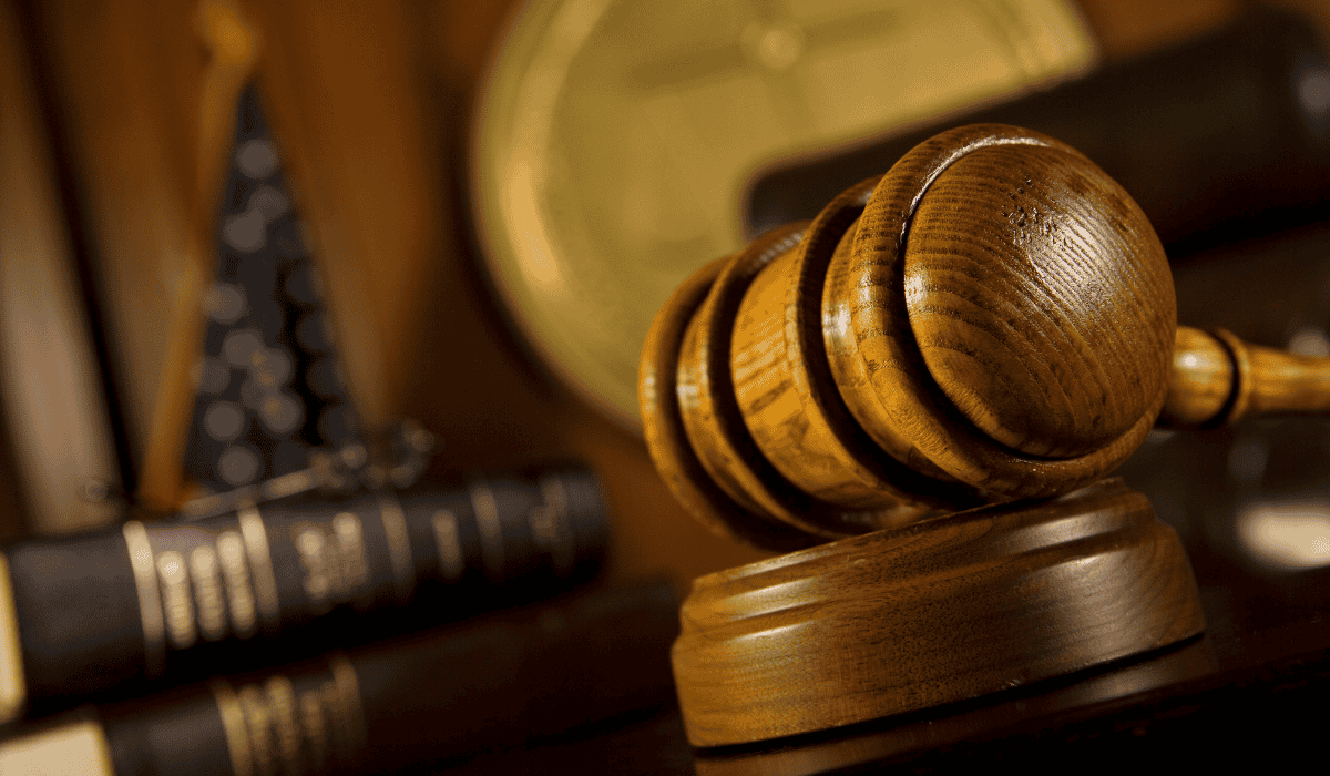 a judge's gavel sits on top of a bookshelf in a courtroom